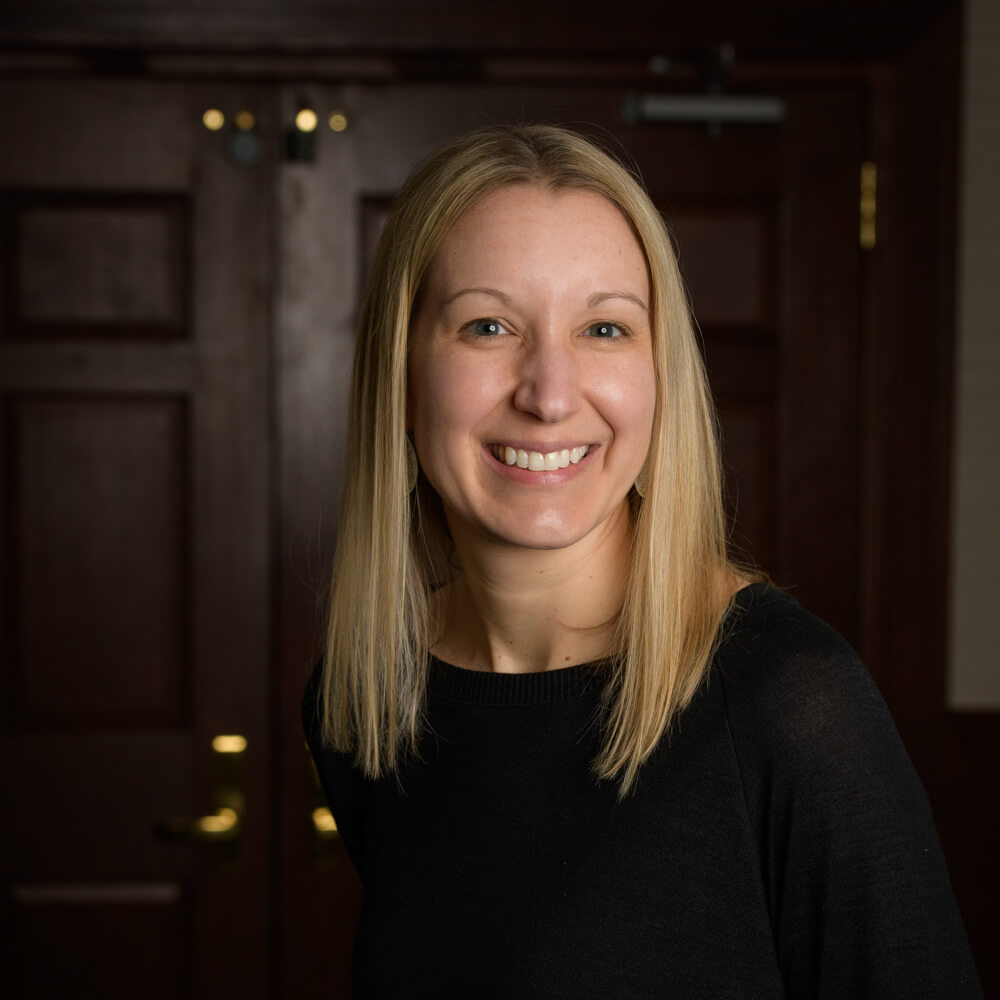 blonde haired woman in front of door