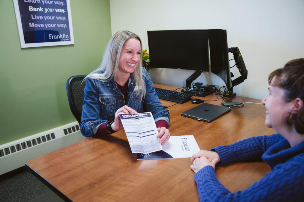 banker showing paperwork to customer