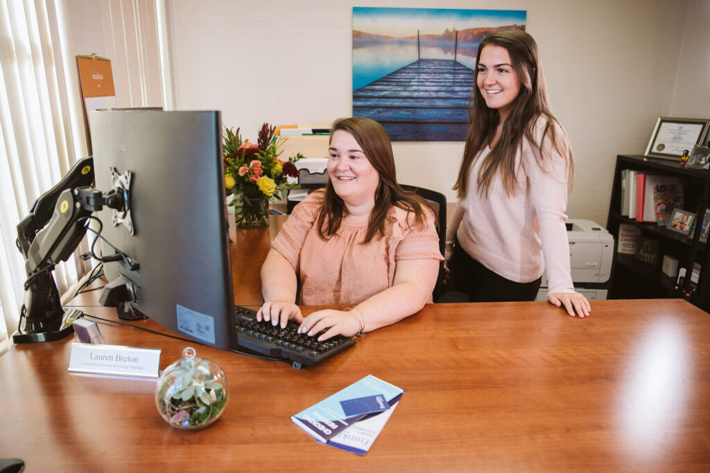 two female bankers at computer